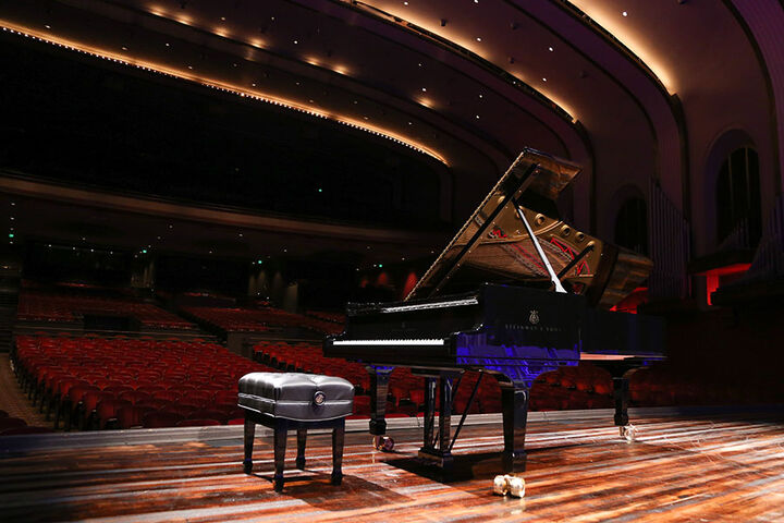 Grand piano sits on the stage of the IU Auditorium.